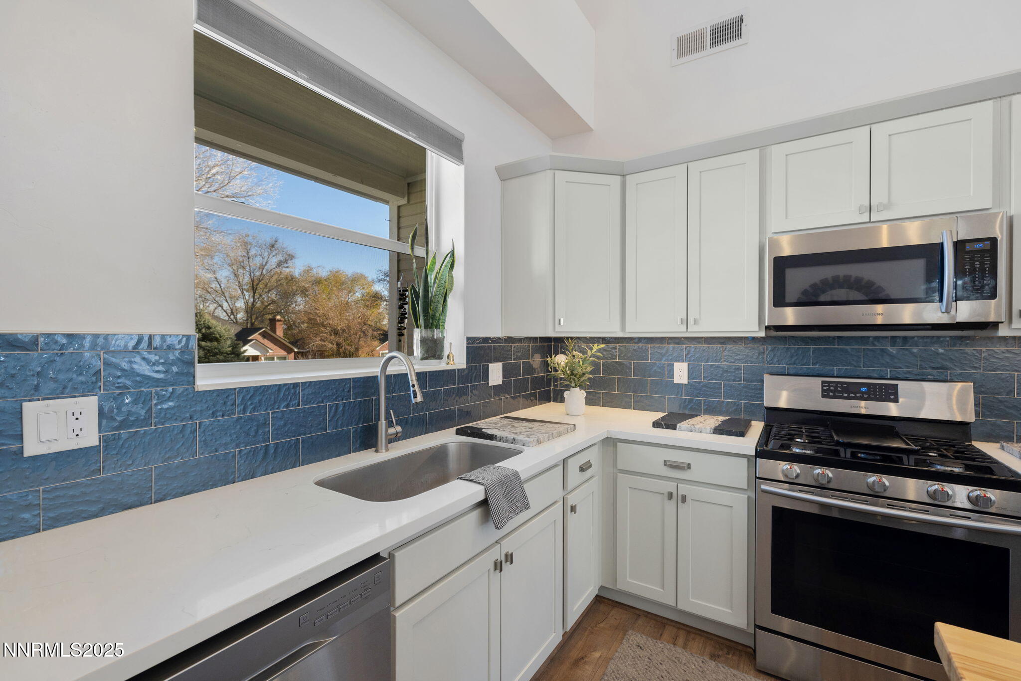 1217 Lander Street Reno, NV 89509 - Photo 4 of 20 a kitchen with a sink stove and microwave