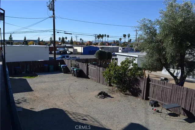 a view of a terrace with furniture and floor to ceiling window