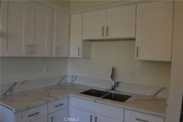 a kitchen with a sink and cabinets