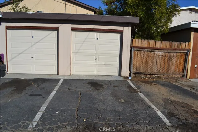 a view of a house with wooden fence