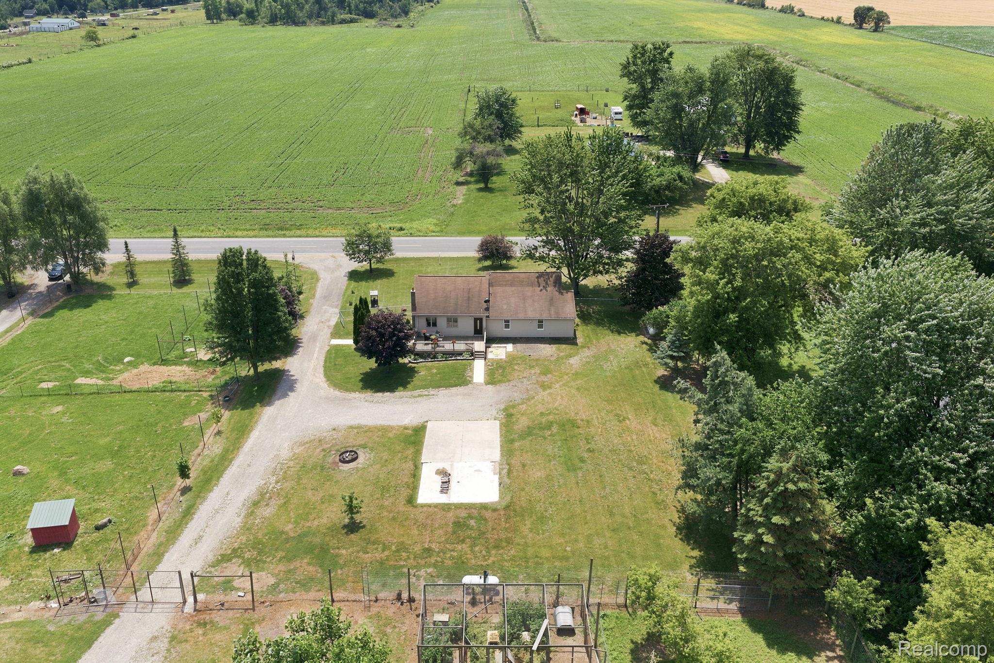 4201 Galbraith Line Road Croswell, MI 48422 - Photo 35 of 39 Expansive property featuring a central residence with a brown roof and light-colored siding