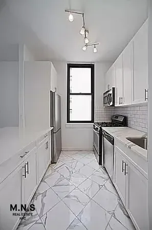 a living room with furniture and a book shelf