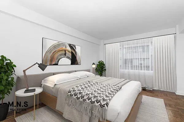 a bedroom with a bed and a window