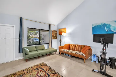 a living room with furniture and a lamp