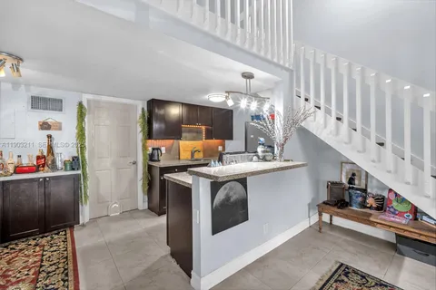 a kitchen with stainless steel appliances granite countertop a sink and cabinets