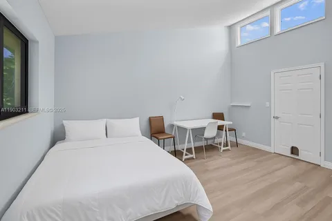 a bed room with a bed and a chair