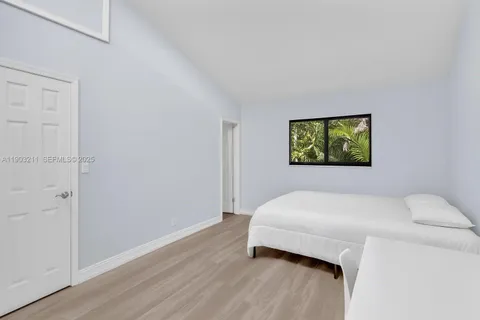 a bedroom with a bed and a painting on the wall