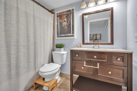 a bathroom with a toilet a sink and a mirror