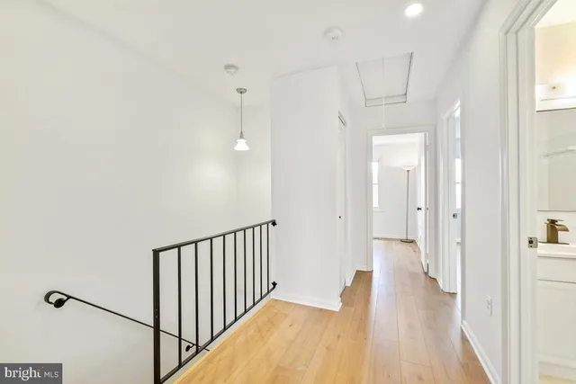 a view of a hallway with wooden floor