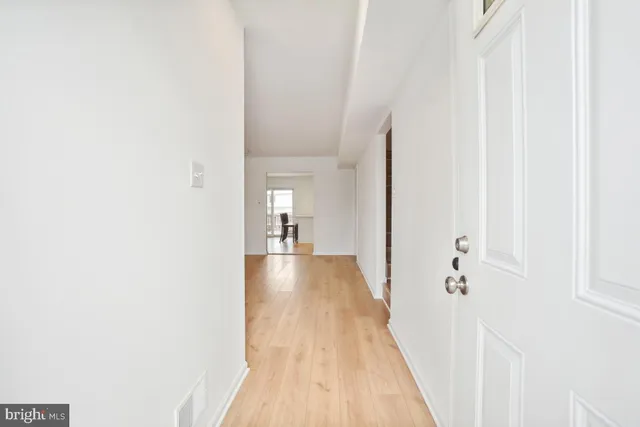 a view of a room with wooden floor and a bathroom