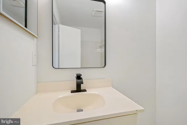 a bathroom with a sink and mirror