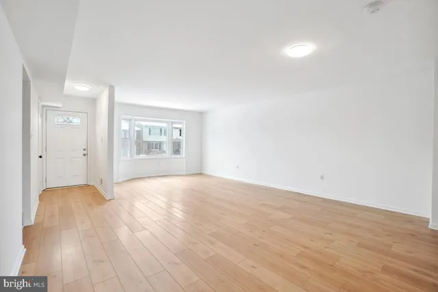 a view of an empty room and a window