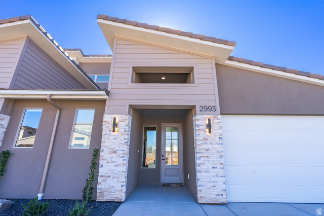 2972 West 570 North Hurricane, UT 84737 - Photo 10 of 104 Entrance to property with stone siding, stucco siding, french doors, and an attached garage