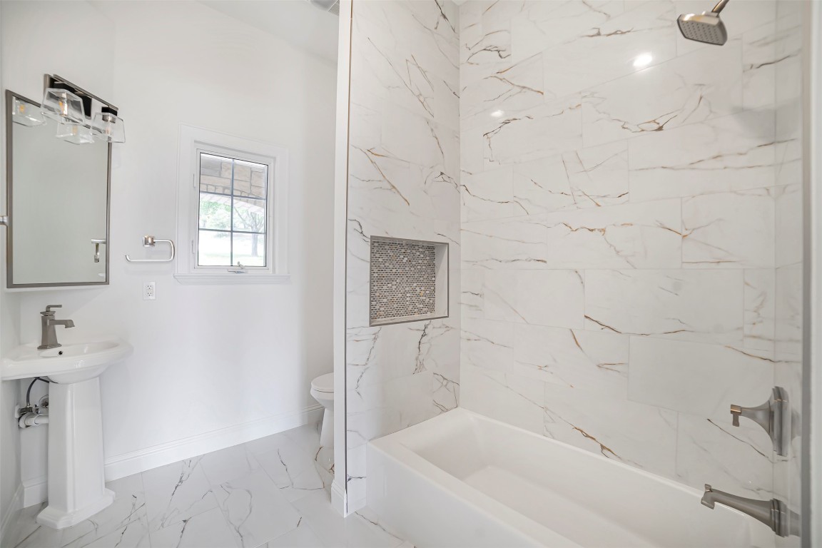 10903 Centennial Trail Austin, TX 78726 - Photo 15 of 31 Full bathroom with marble finish flooring and shower combination