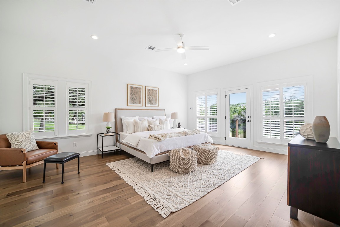 10903 Centennial Trail Austin, TX 78726 - Photo 17 of 31 Beautiful primary bedroom with access to exterior, recessed lighting, wood finished floors, and ceiling fan