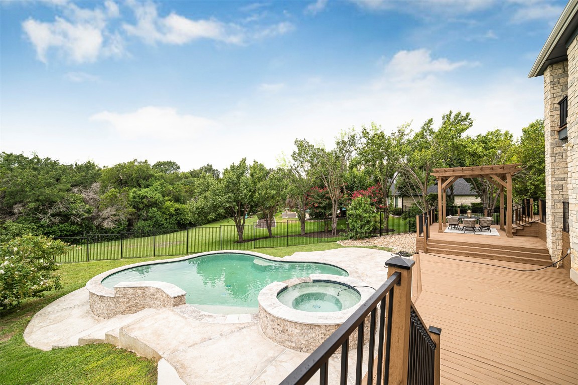 10903 Centennial Trail Austin, TX 78726 - Photo 29 of 31 Newly remodeled heated swimming pool with connected hot tub, deck, and large backyard with ample space for entertaining
