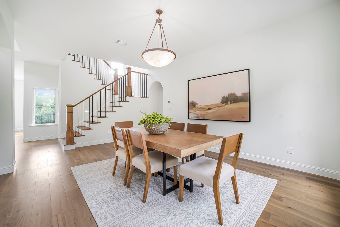 10903 Centennial Trail Austin, TX 78726 - Photo 7 of 31 Dining room with stairs, arched walkways, and wood finished floors