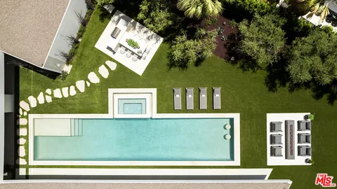 a view of a house with pool yard and outdoor seating