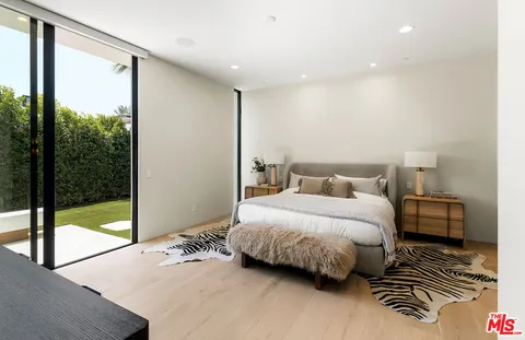 a front view of a house with garden yard and patio