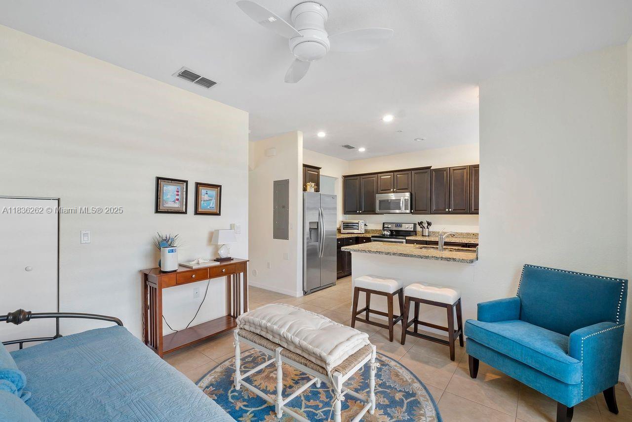 2851 Prospect Road, Unit 1306 Tamarac, FL 33309 - Photo 13 of 39 a living room with furniture and kitchen view