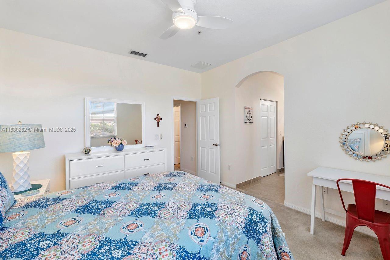 2851 Prospect Road, Unit 1306 Tamarac, FL 33309 - Photo 18 of 39 a bedroom with a bed and a chair
