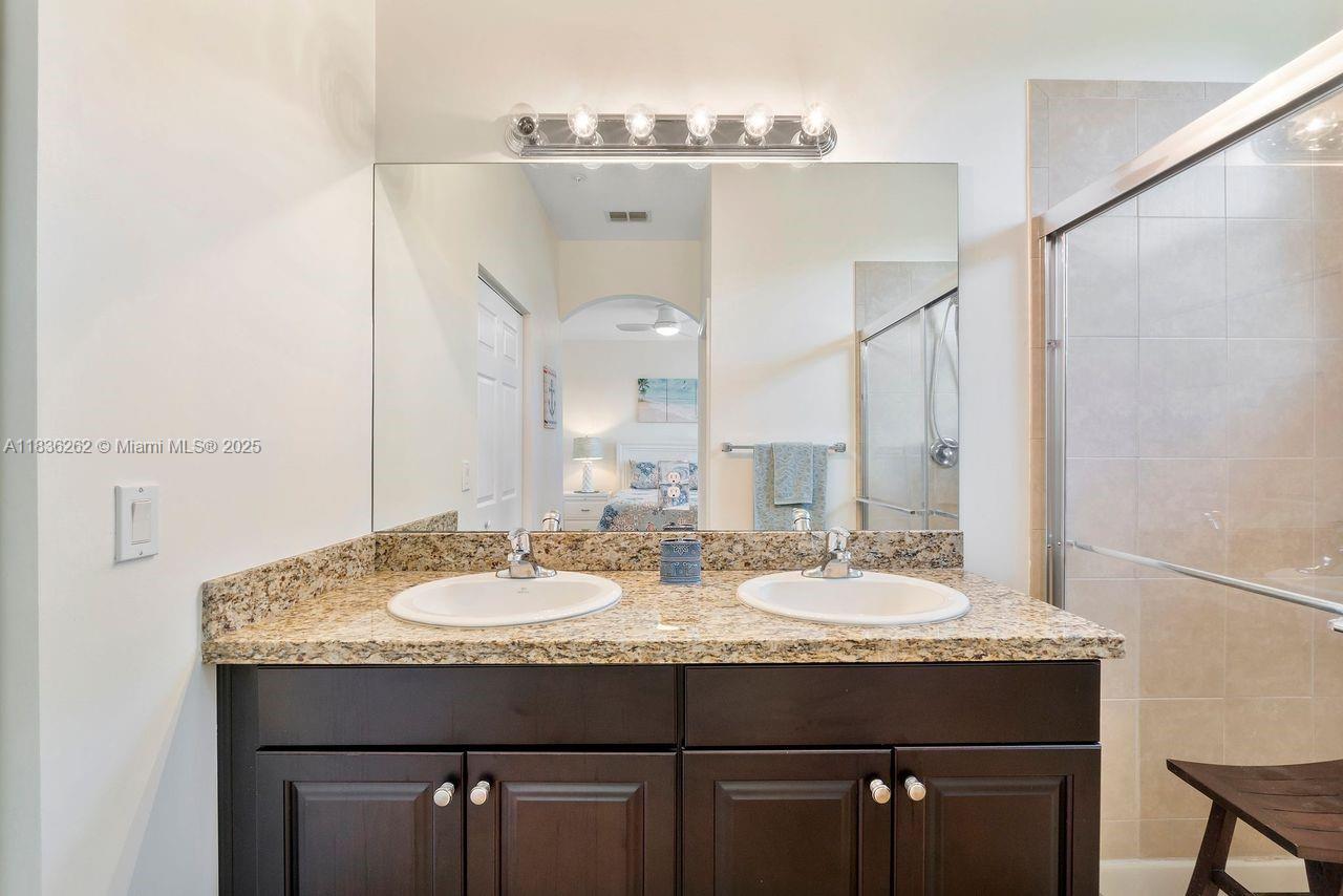 2851 Prospect Road, Unit 1306 Tamarac, FL 33309 - Photo 20 of 39 a bathroom with a granite countertop sink and a mirror