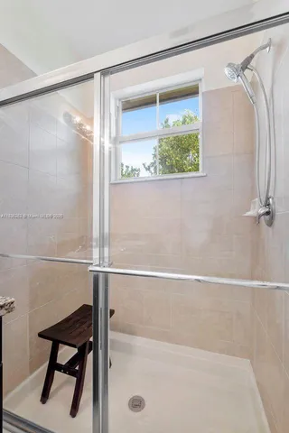 a bathroom with a shower and a shower