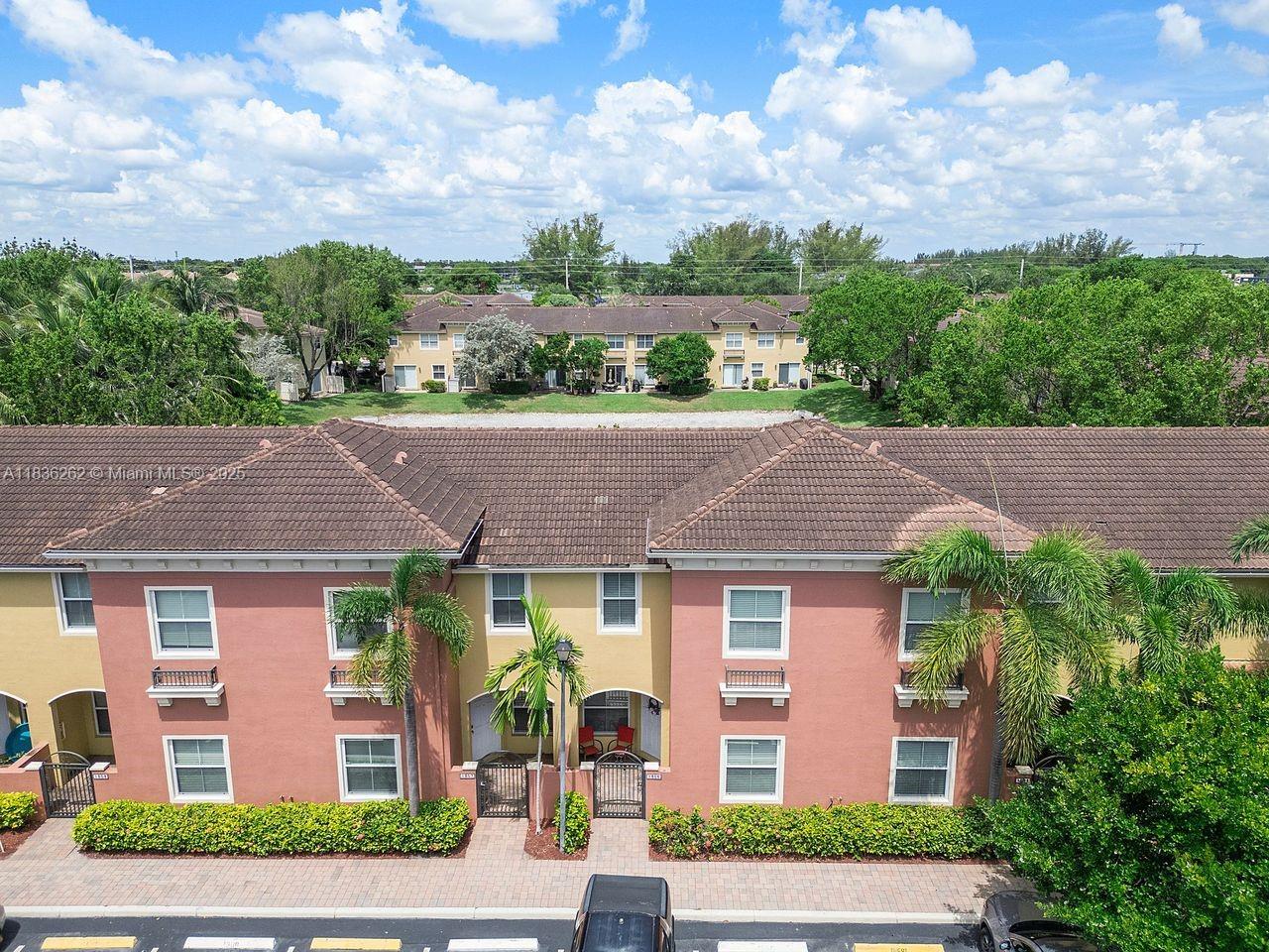 2851 Prospect Road, Unit 1306 Tamarac, FL 33309 - Photo 32 of 39 an aerial view of a house with a yard and potted plants