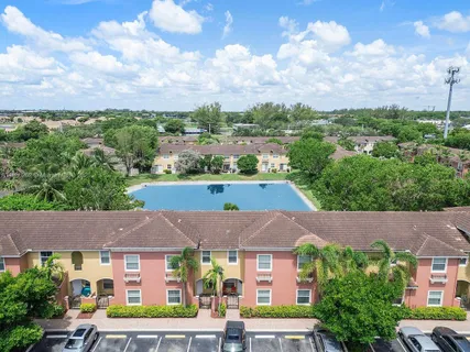 an aerial view of residential houses with outdoor space and city view