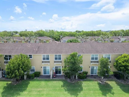 an aerial view of house with yard swimming pool and mountains