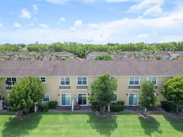 an aerial view of house with yard swimming pool and mountains