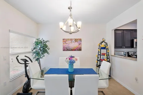 a view of a dining room with furniture and chandelier
