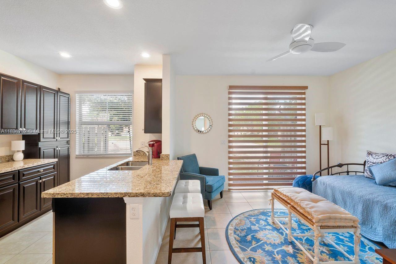2851 Prospect Road, Unit 1306 Tamarac, FL 33309 - Photo 9 of 39 a kitchen with a table chairs in it and wooden floors