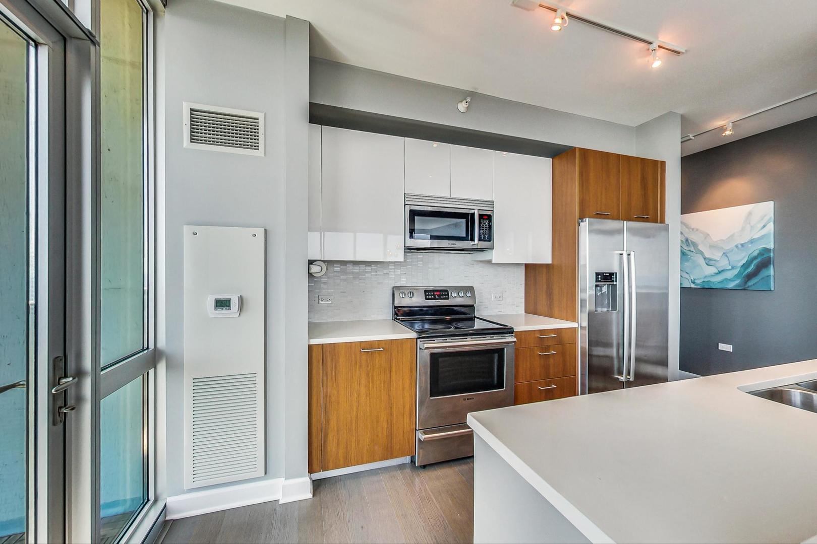 Undisclosed Address Chicago, IL 60616 - Photo 11 of 31 a kitchen with stainless steel appliances granite countertop a refrigerator stove microwave and sink