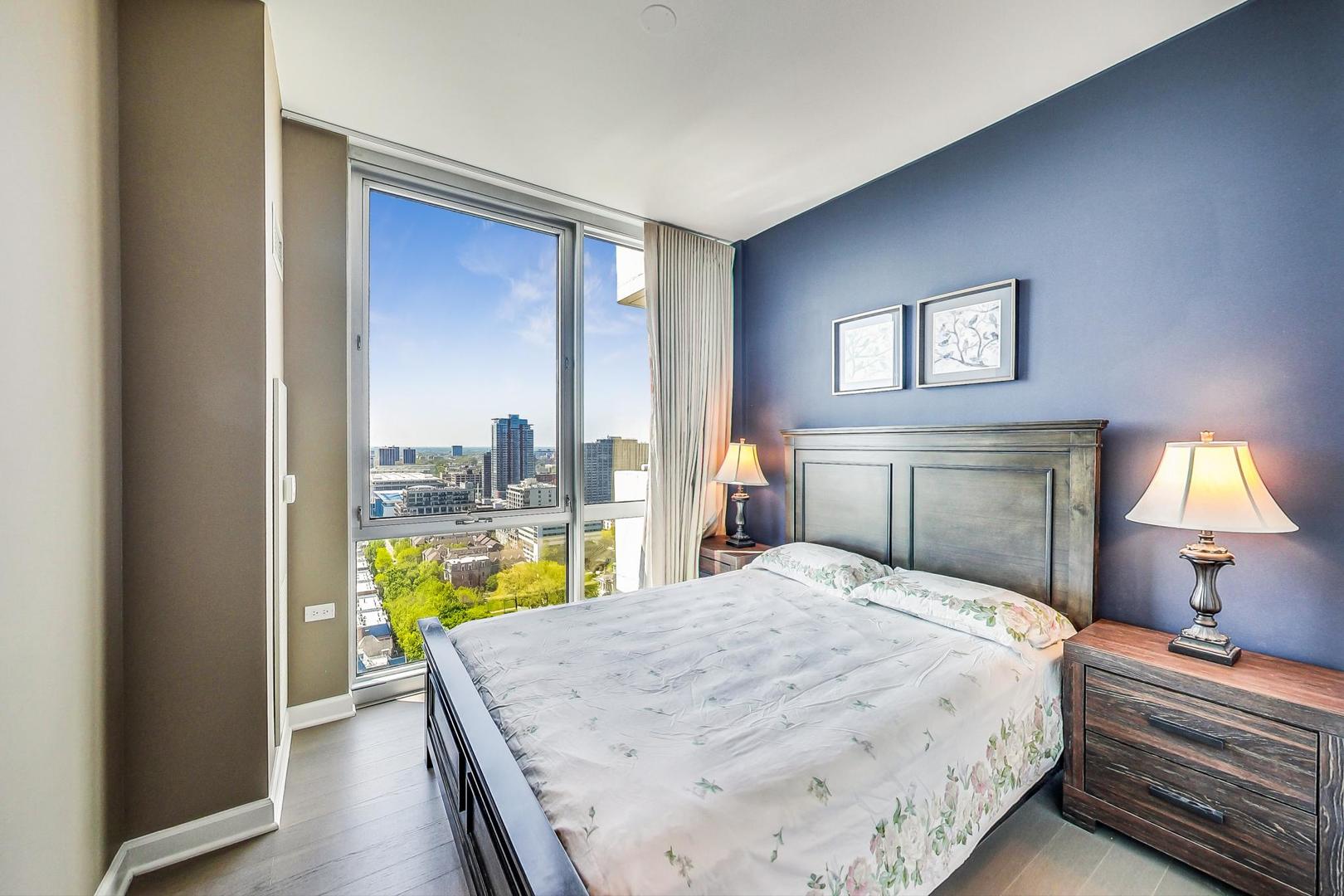 Undisclosed Address Chicago, IL 60616 - Photo 20 of 31 a bedroom with a bed and a lamp on table