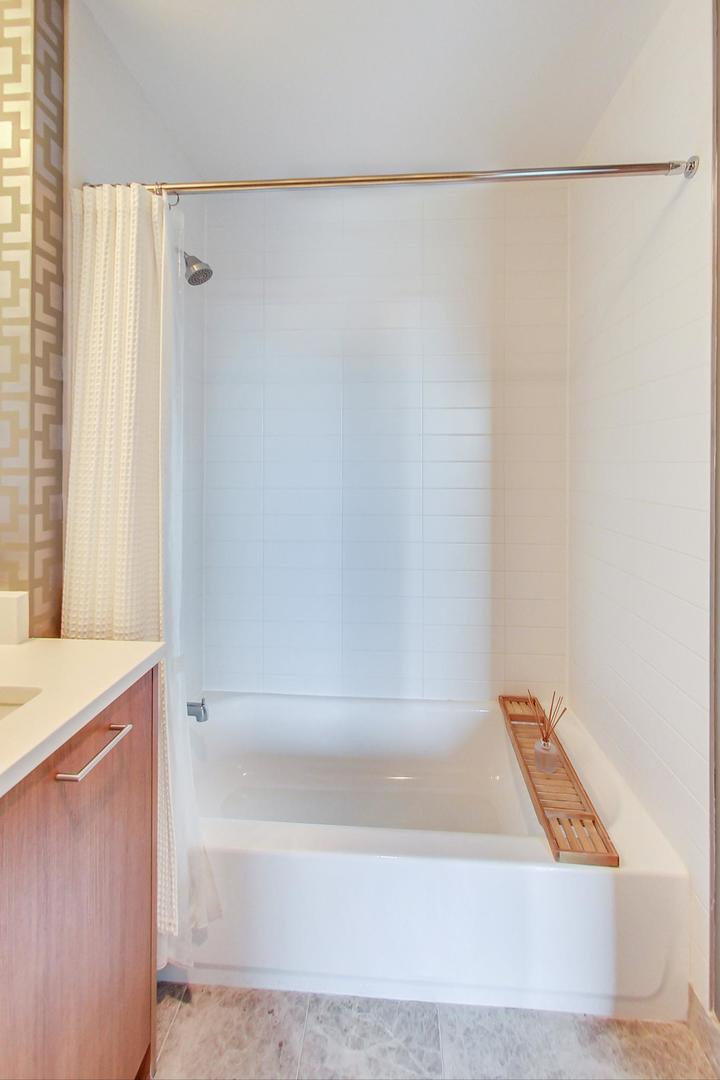 Undisclosed Address Chicago, IL 60616 - Photo 22 of 31 a bathroom with a bathtub and a shower