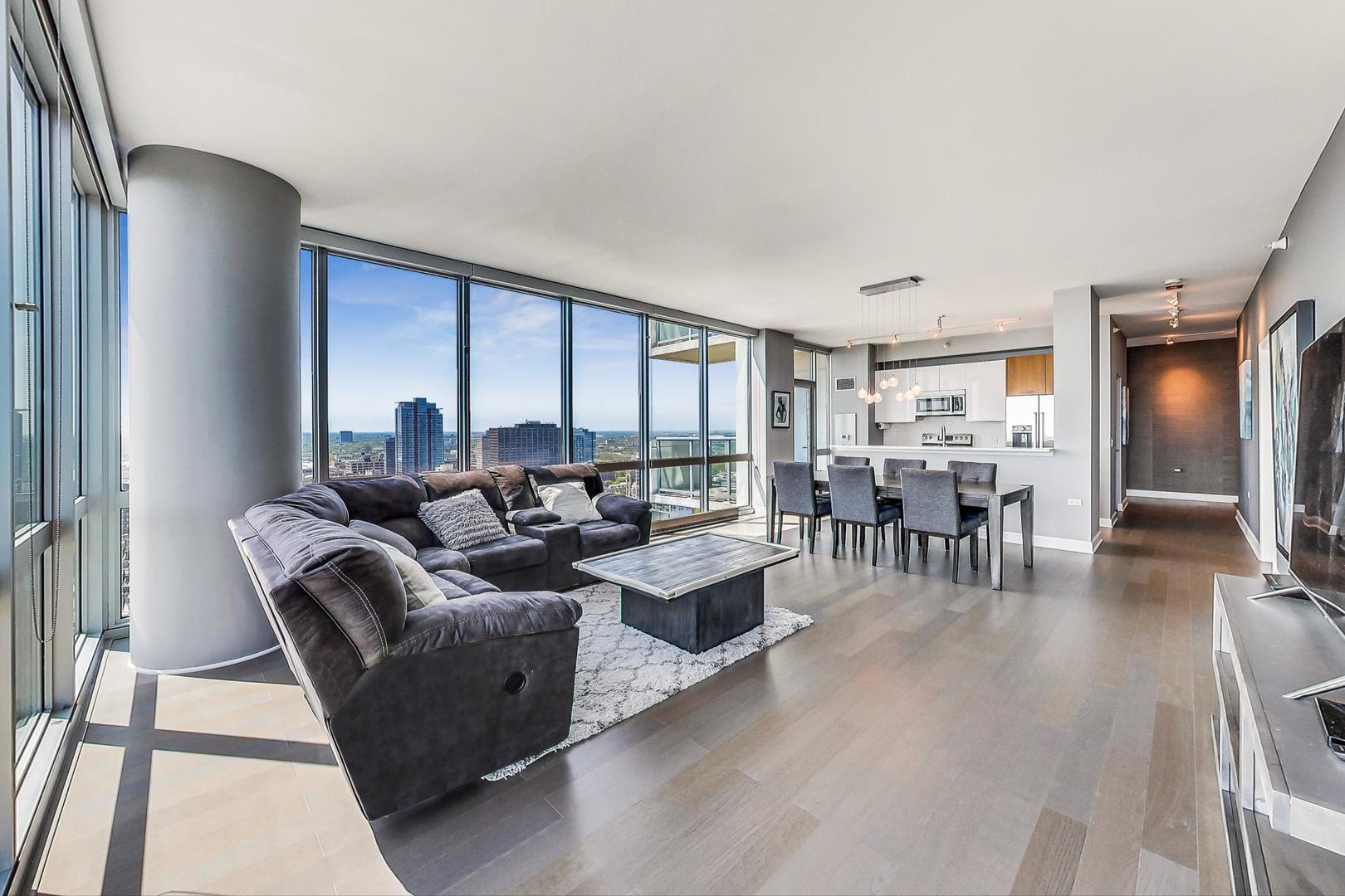 Undisclosed Address Chicago, IL 60616 - Photo 7 of 31 a living room with furniture two large window and wooden floor