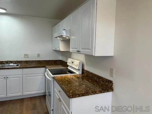 1604 Montecito Road, Unit 10 Ramona, CA 92065 - Photo 4 of 45 a kitchen with granite countertop white cabinets and a sink