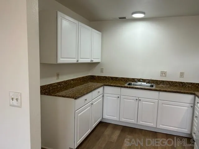 1604 Montecito Road, Unit 10 Ramona, CA 92065 - Photo 6 of 45 a kitchen with granite countertop white cabinets and a sink