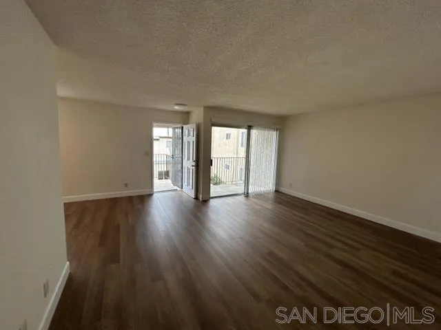 1604 Montecito Road, Unit 10 Ramona, CA 92065 - Photo 7 of 45 a view of an empty room with wooden floor and a window
