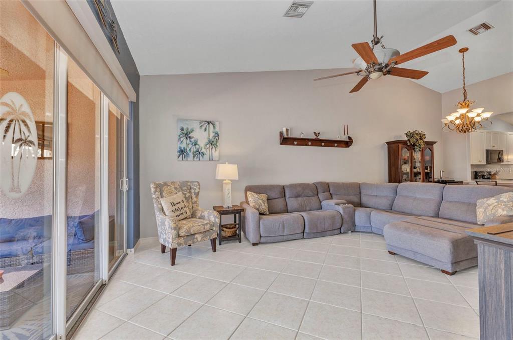 3715 Albacete Circle, Unit 93 Punta Gorda, FL 33950 - Photo 13 of 32 a living room with furniture and a chandelier