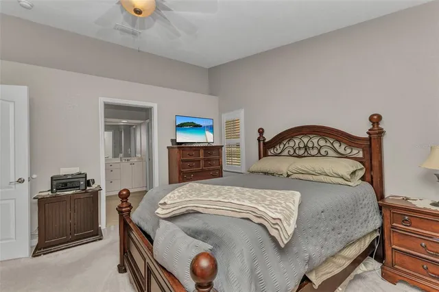 a bedroom with a bed and a view of kitchen