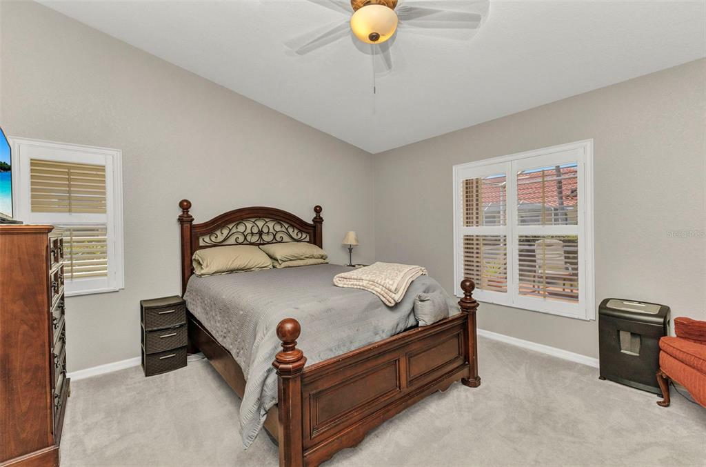 3715 Albacete Circle, Unit 93 Punta Gorda, FL 33950 - Photo 15 of 32 a bed sitting in a bedroom next to a window