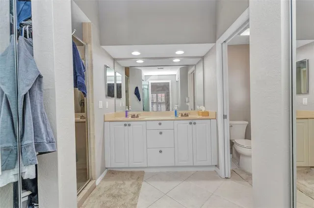 a bathroom with a double vanity sink toilet and shower