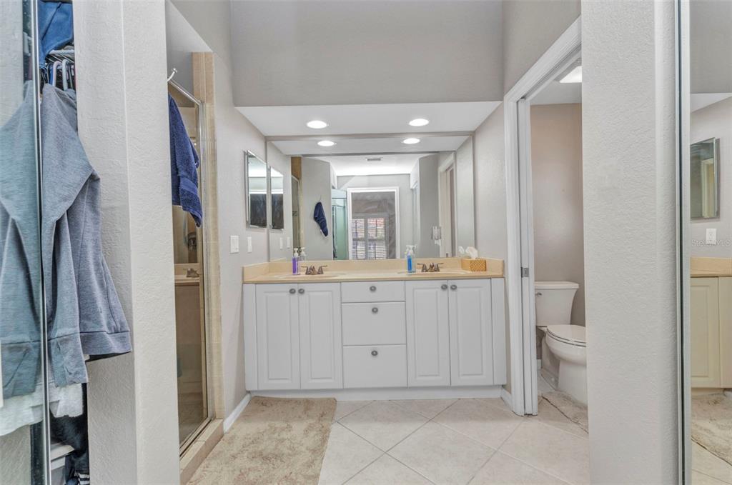 3715 Albacete Circle, Unit 93 Punta Gorda, FL 33950 - Photo 16 of 32 a bathroom with a double vanity sink toilet and shower