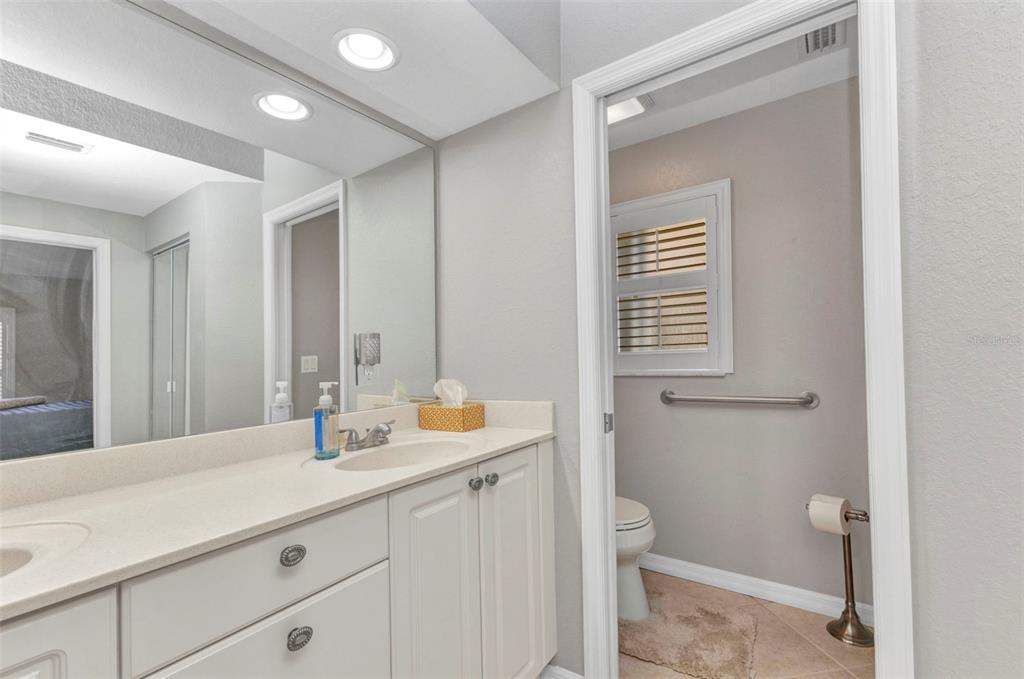 3715 Albacete Circle, Unit 93 Punta Gorda, FL 33950 - Photo 17 of 32 a bathroom with a sink a toilet and a mirror