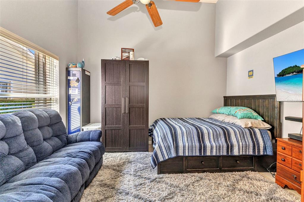 3715 Albacete Circle, Unit 93 Punta Gorda, FL 33950 - Photo 19 of 32 a bedroom with a bed couch and a large window