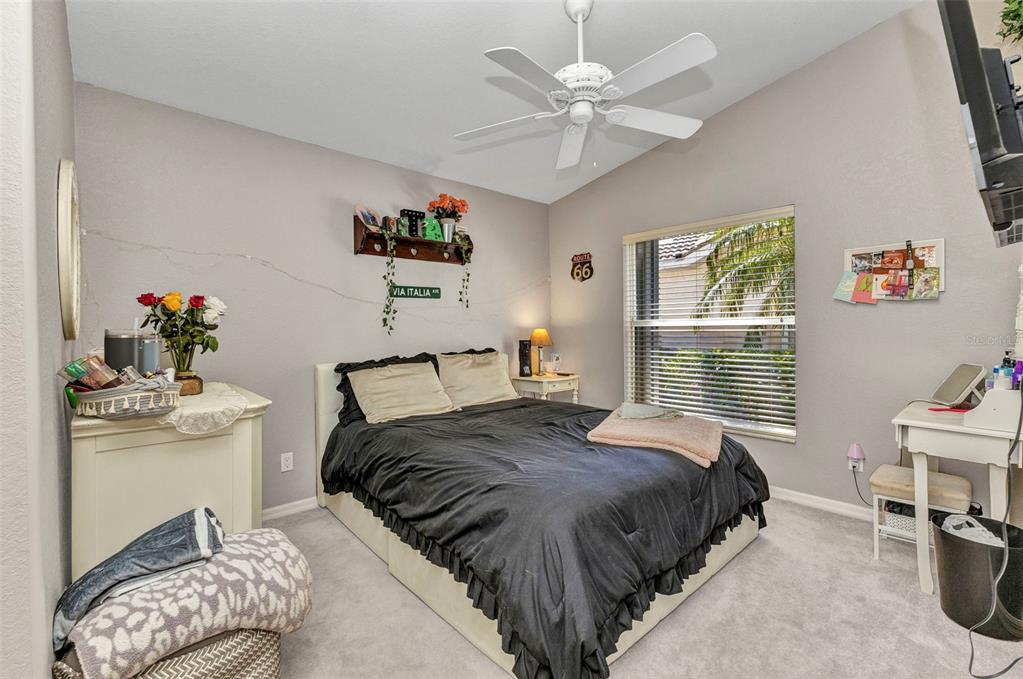3715 Albacete Circle, Unit 93 Punta Gorda, FL 33950 - Photo 21 of 32 a bedroom with a bed and a chandelier