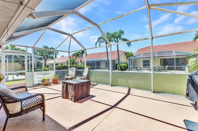a view of a patio with a table and chairs under an umbrella