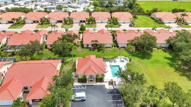 an aerial view of residential houses with outdoor space and street view